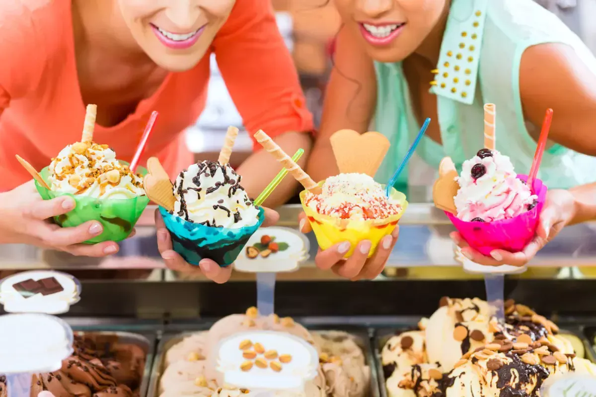 Close-up of colorful ice cream sundaes with toppings.