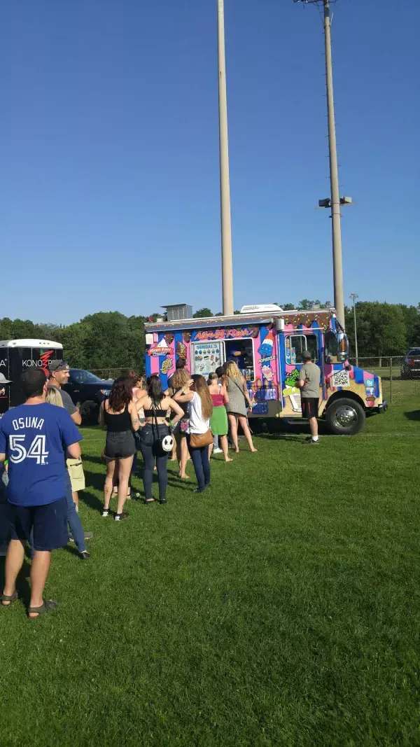 Mega Cone Ice cream truck serving customers outdoors.